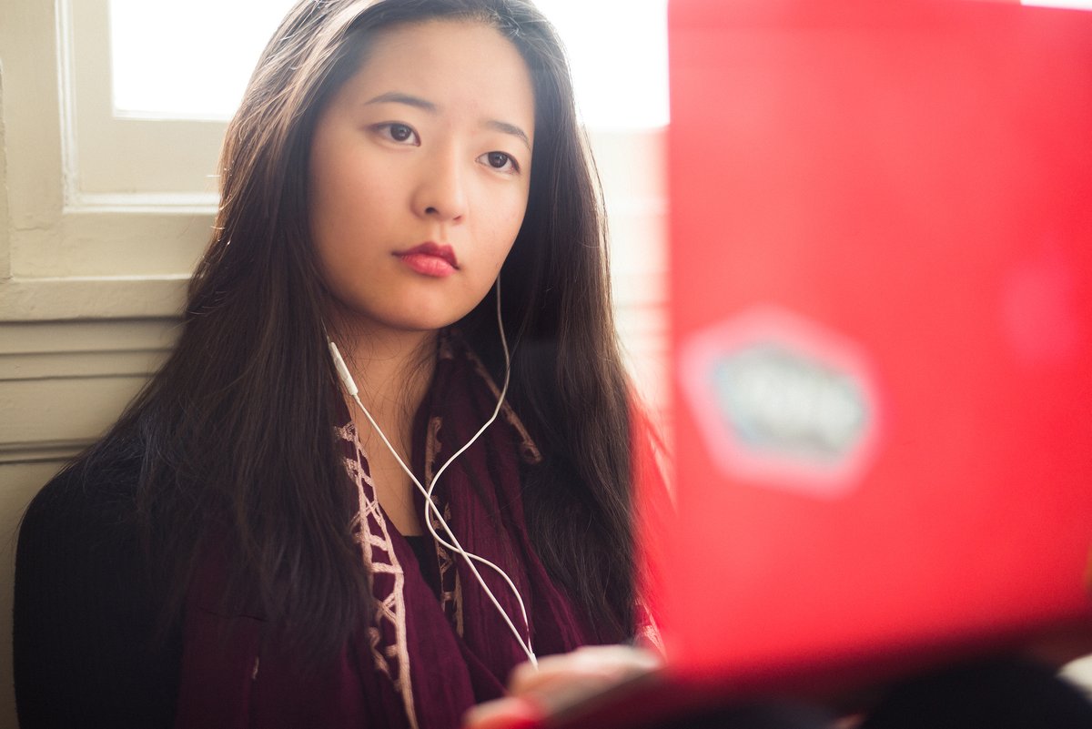Xiaotian on laptop in residence hall
